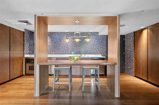 a view of a room with dining table and chairs
