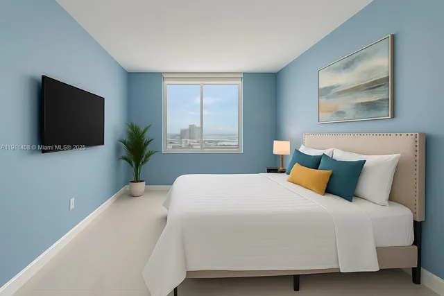 a bedroom with a large bed and a flat screen tv