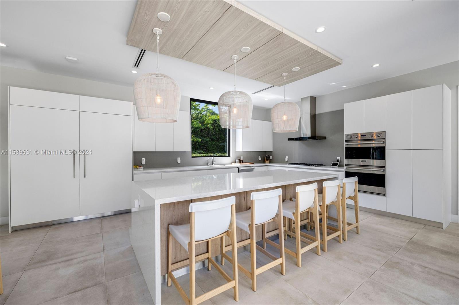 5840 Moss Ranch Road Pinecrest, FL 33156 - Photo 19 of 83 a kitchen with kitchen island cabinets and chairs in it