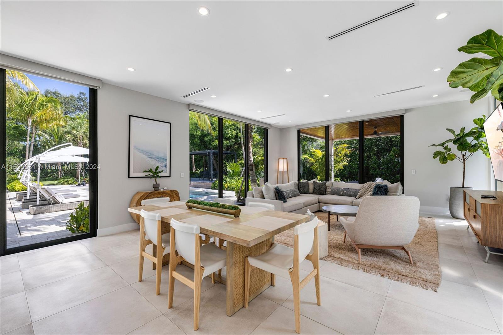 5840 Moss Ranch Road Pinecrest, FL 33156 - Photo 25 of 83 a view of a dining room with furniture window and wooden floor