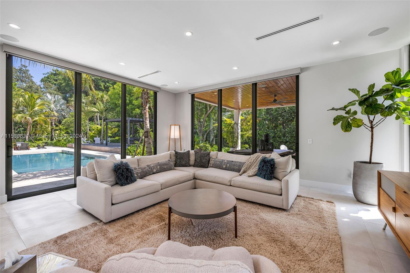5840 Moss Ranch Road Pinecrest, FL 33156 - Photo 26 of 83 a living room with furniture and a large window
