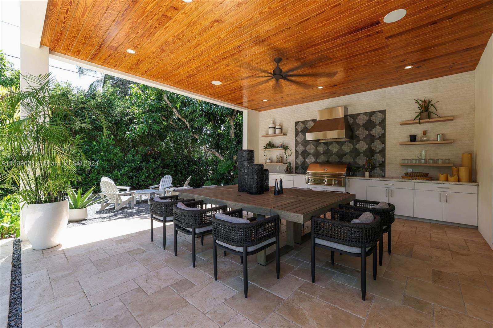 5840 Moss Ranch Road Pinecrest, FL 33156 - Photo 29 of 83 a view of a patio with a dining table and chairs