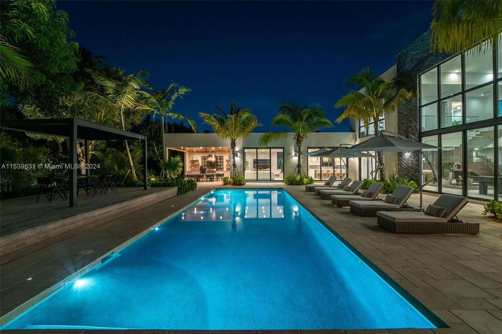 5840 Moss Ranch Road Pinecrest, FL 33156 - Photo 36 of 83 a view of a swimming pool with a patio