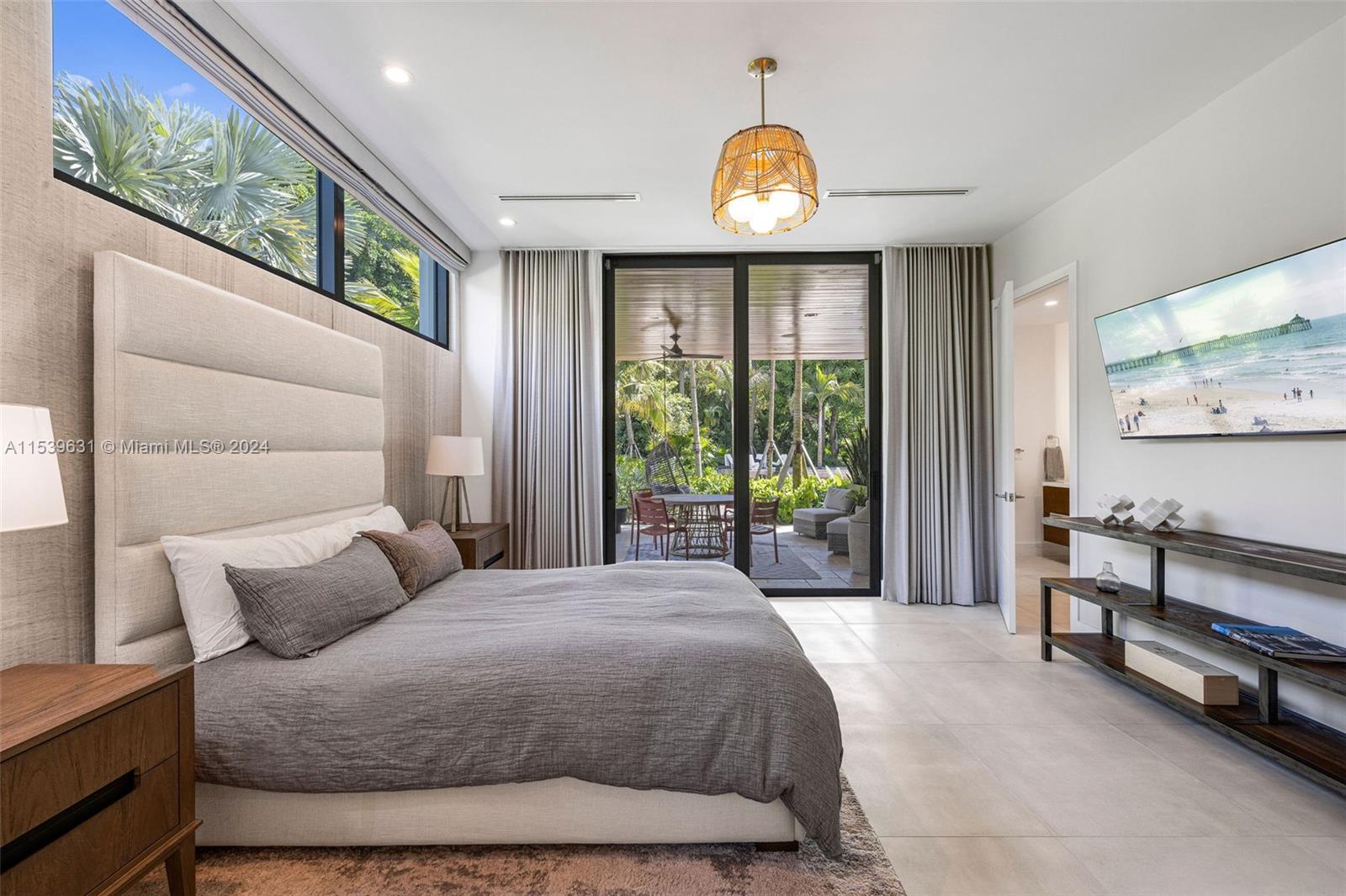 5840 Moss Ranch Road Pinecrest, FL 33156 - Photo 40 of 83 a spacious bedroom with a bed and a large window