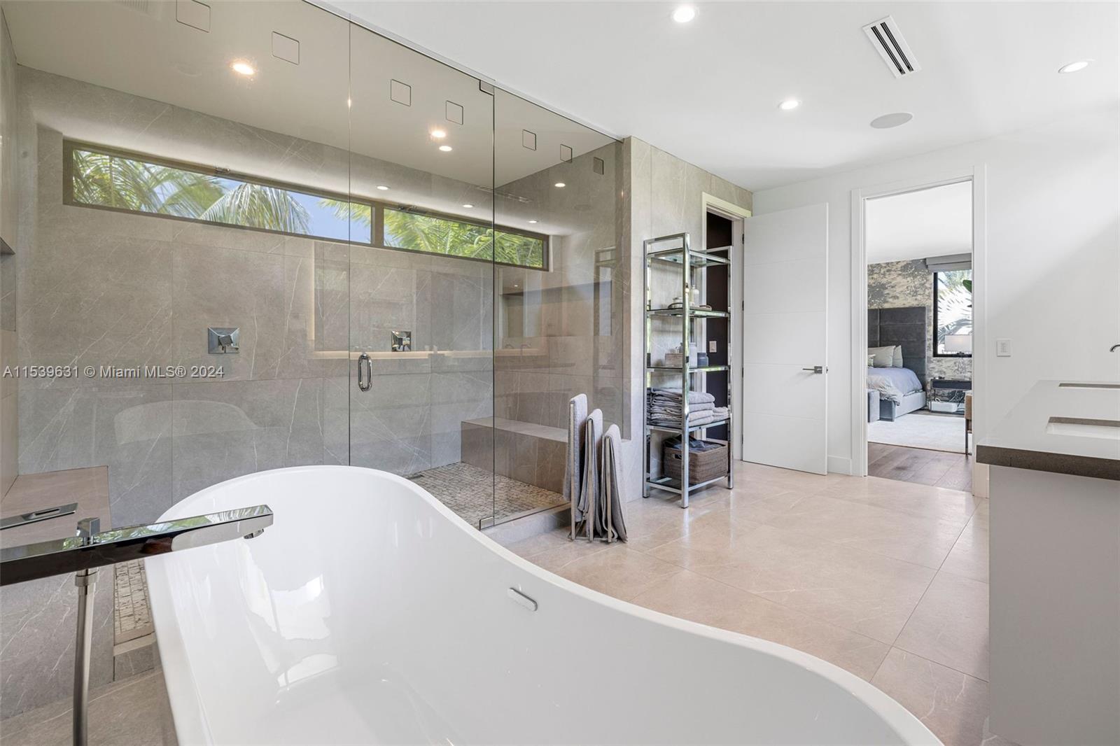 5840 Moss Ranch Road Pinecrest, FL 33156 - Photo 46 of 83 a bathroom with a tub a sink and a large window