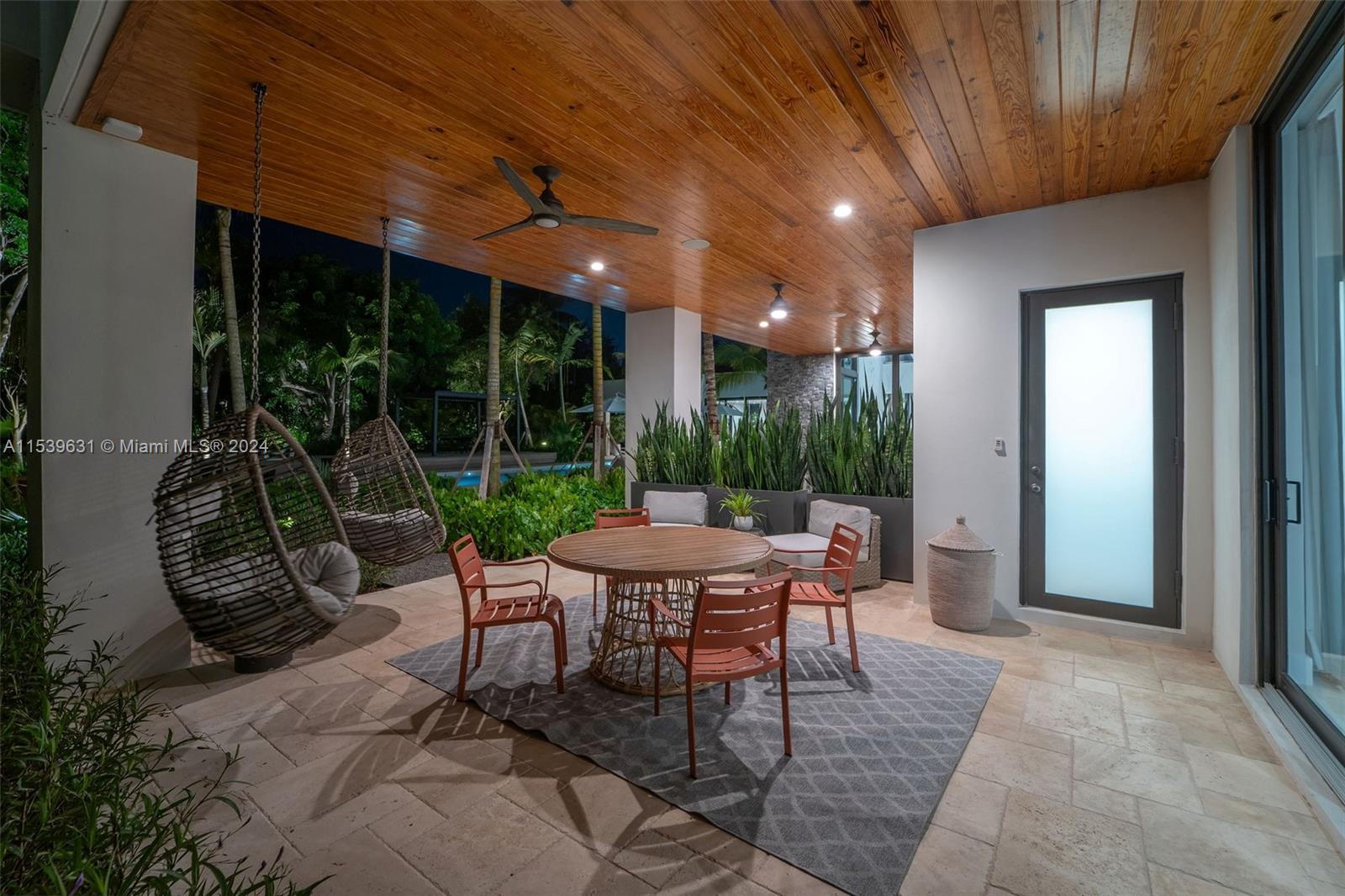 5840 Moss Ranch Road Pinecrest, FL 33156 - Photo 50 of 83 a view of a patio with a dining table and chairs with wooden floor and fence
