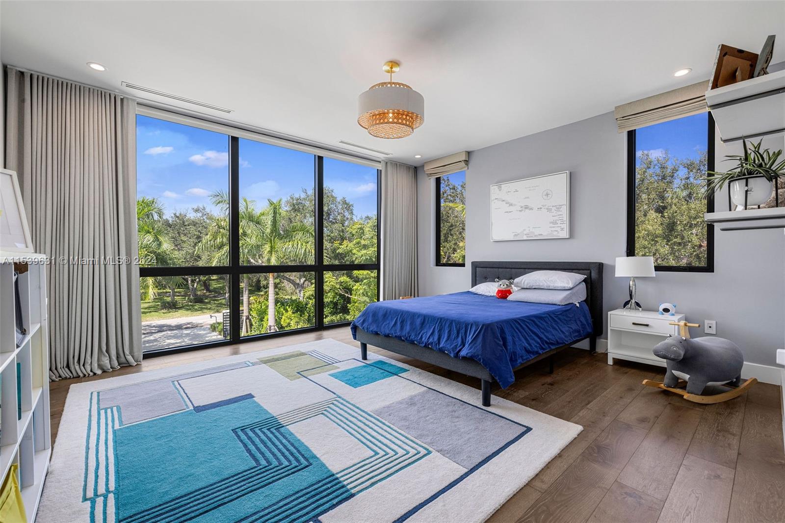 5840 Moss Ranch Road Pinecrest, FL 33156 - Photo 52 of 83 a spacious bedroom with a bed and a large window