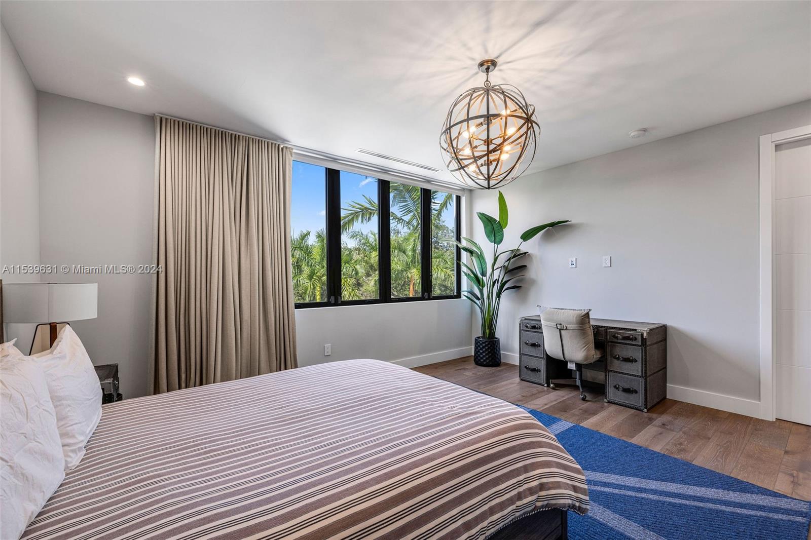 5840 Moss Ranch Road Pinecrest, FL 33156 - Photo 55 of 83 a bedroom with a bed and a chandelier