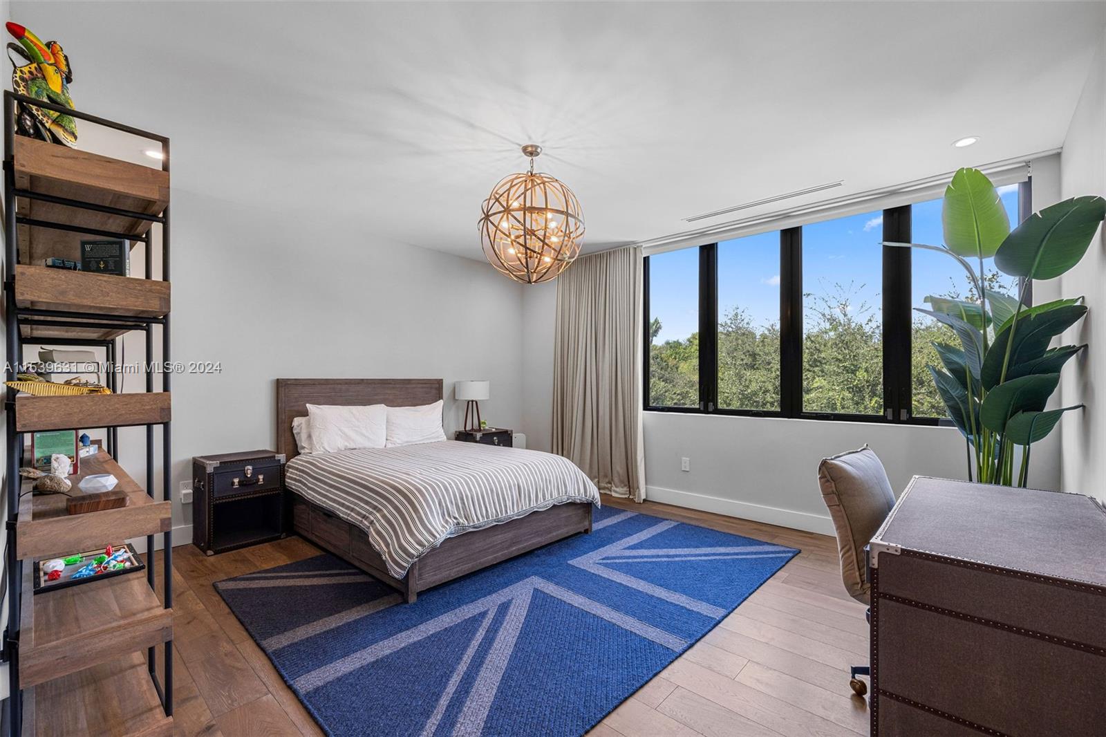 5840 Moss Ranch Road Pinecrest, FL 33156 - Photo 56 of 83 a bedroom with a bed a bookshelf and a large window