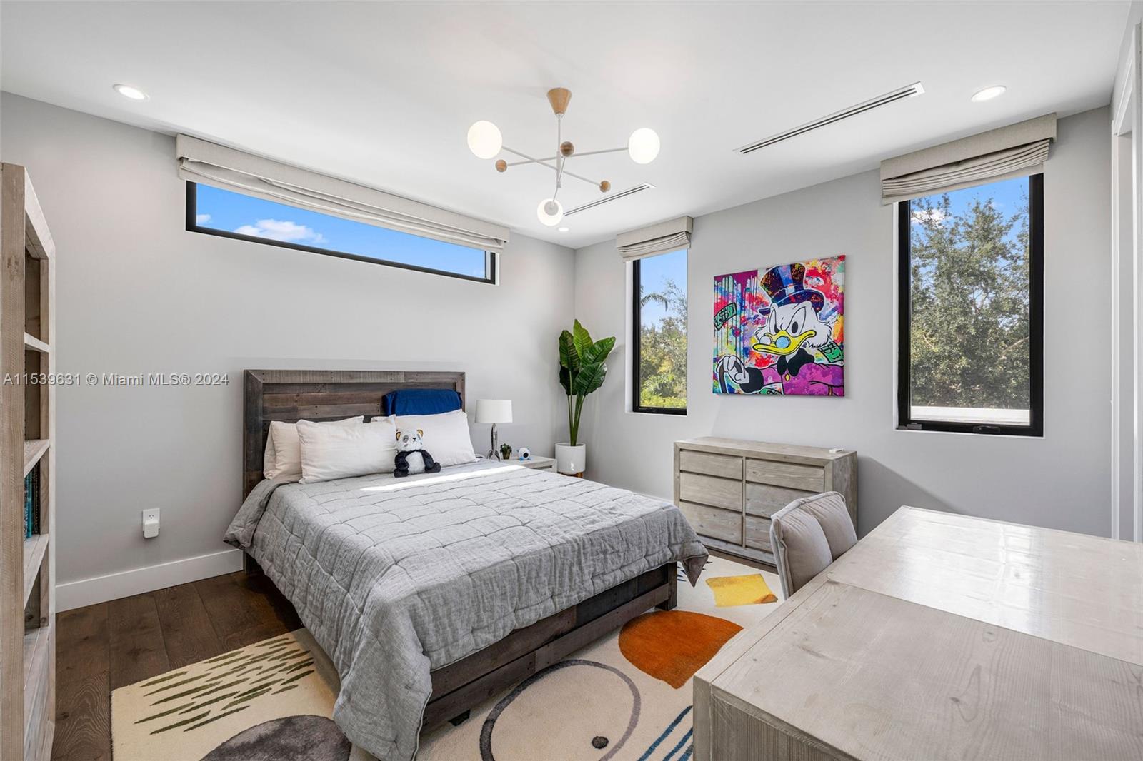 5840 Moss Ranch Road Pinecrest, FL 33156 - Photo 58 of 83 a bedroom with a bed a painting on the wall and a chandelier