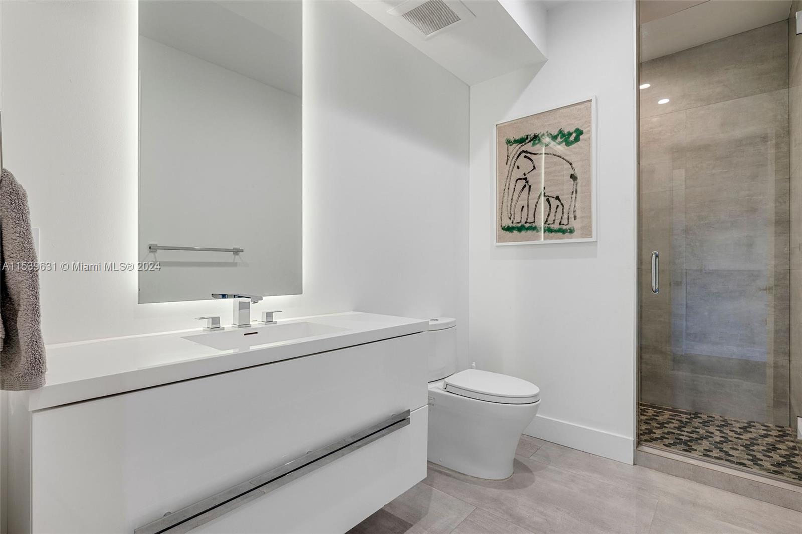 5840 Moss Ranch Road Pinecrest, FL 33156 - Photo 61 of 83 a bathroom with a sink a toilet and a mirror