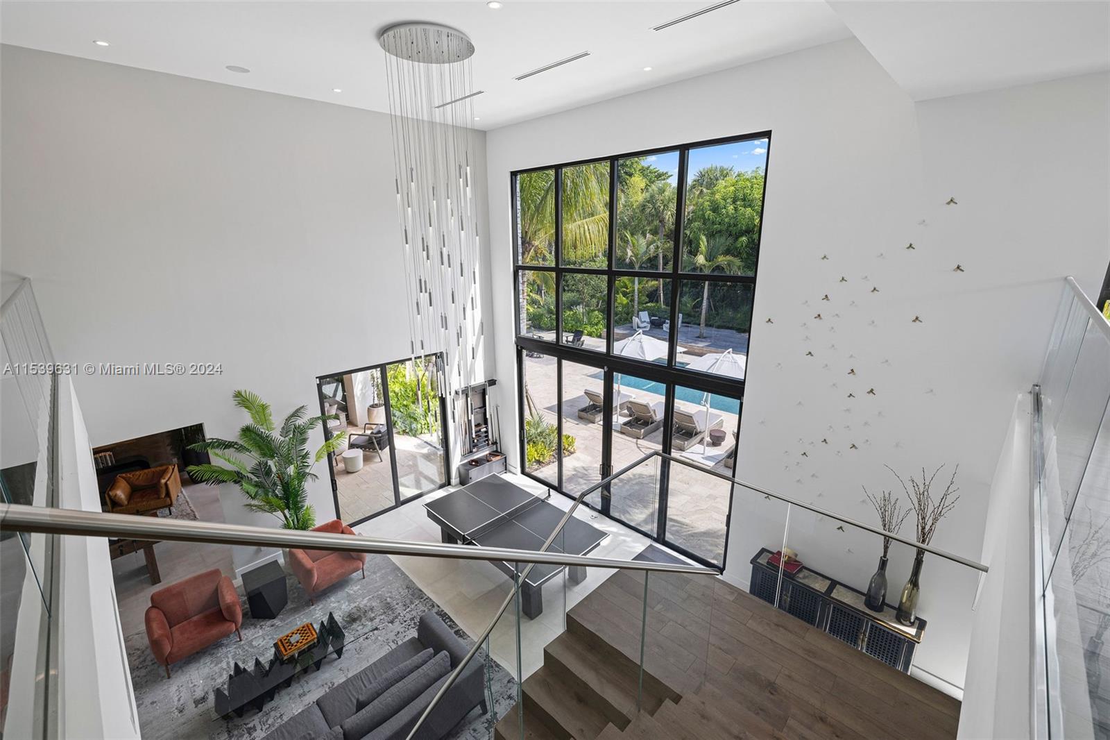 5840 Moss Ranch Road Pinecrest, FL 33156 - Photo 65 of 83 a living room with furniture and a floor to ceiling window