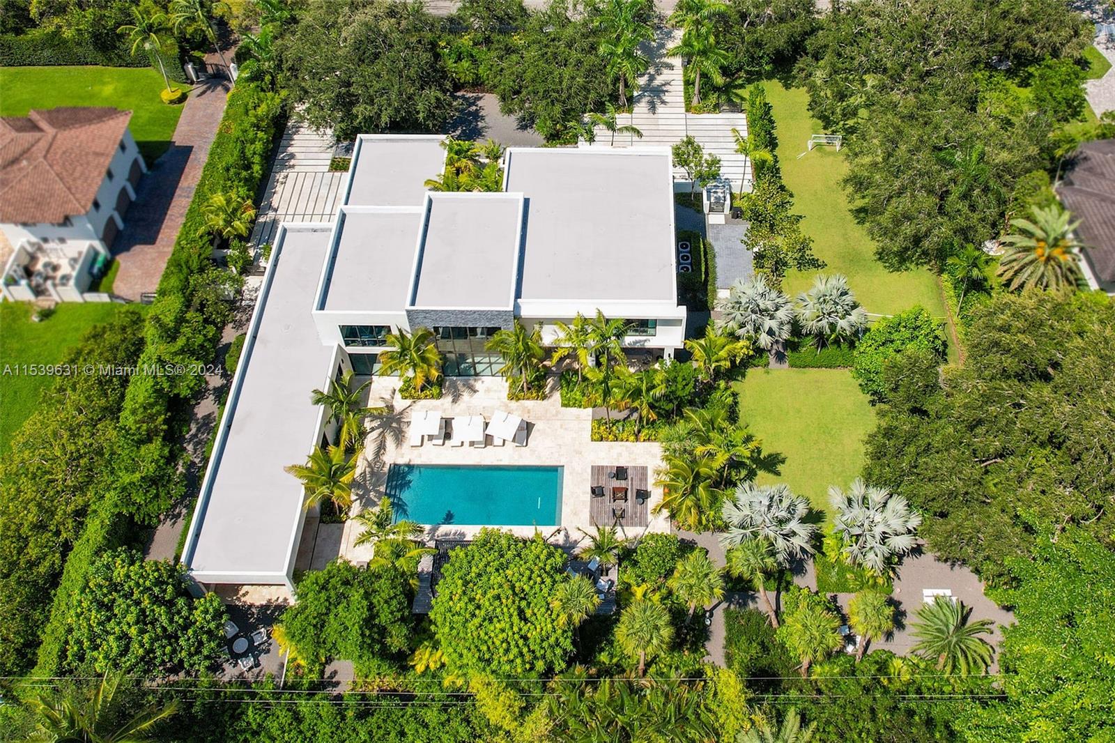 5840 Moss Ranch Road Pinecrest, FL 33156 - Photo 69 of 83 an aerial view of a house with a yard and lake view