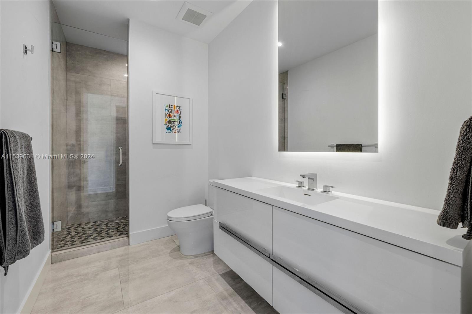 5840 Moss Ranch Road Pinecrest, FL 33156 - Photo 73 of 83 a bathroom with a double vanity sink toilet and shower