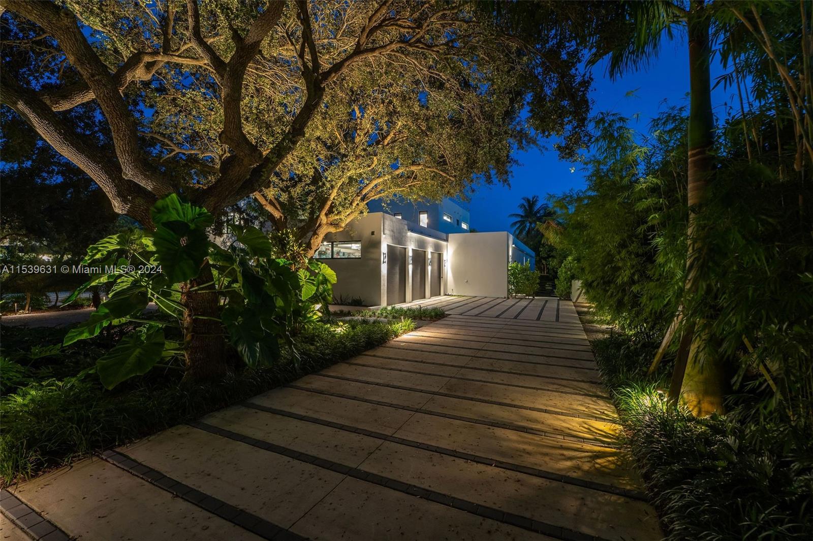 5840 Moss Ranch Road Pinecrest, FL 33156 - Photo 75 of 83 a front view of a house with a garden