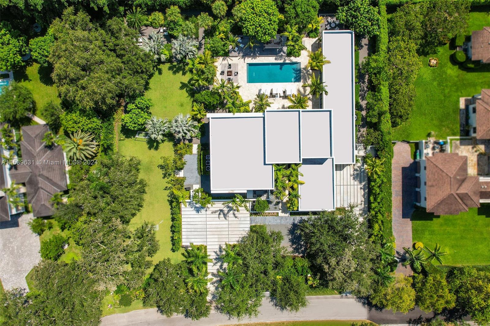 5840 Moss Ranch Road Pinecrest, FL 33156 - Photo 8 of 83 an aerial view of a house with a yard and garden