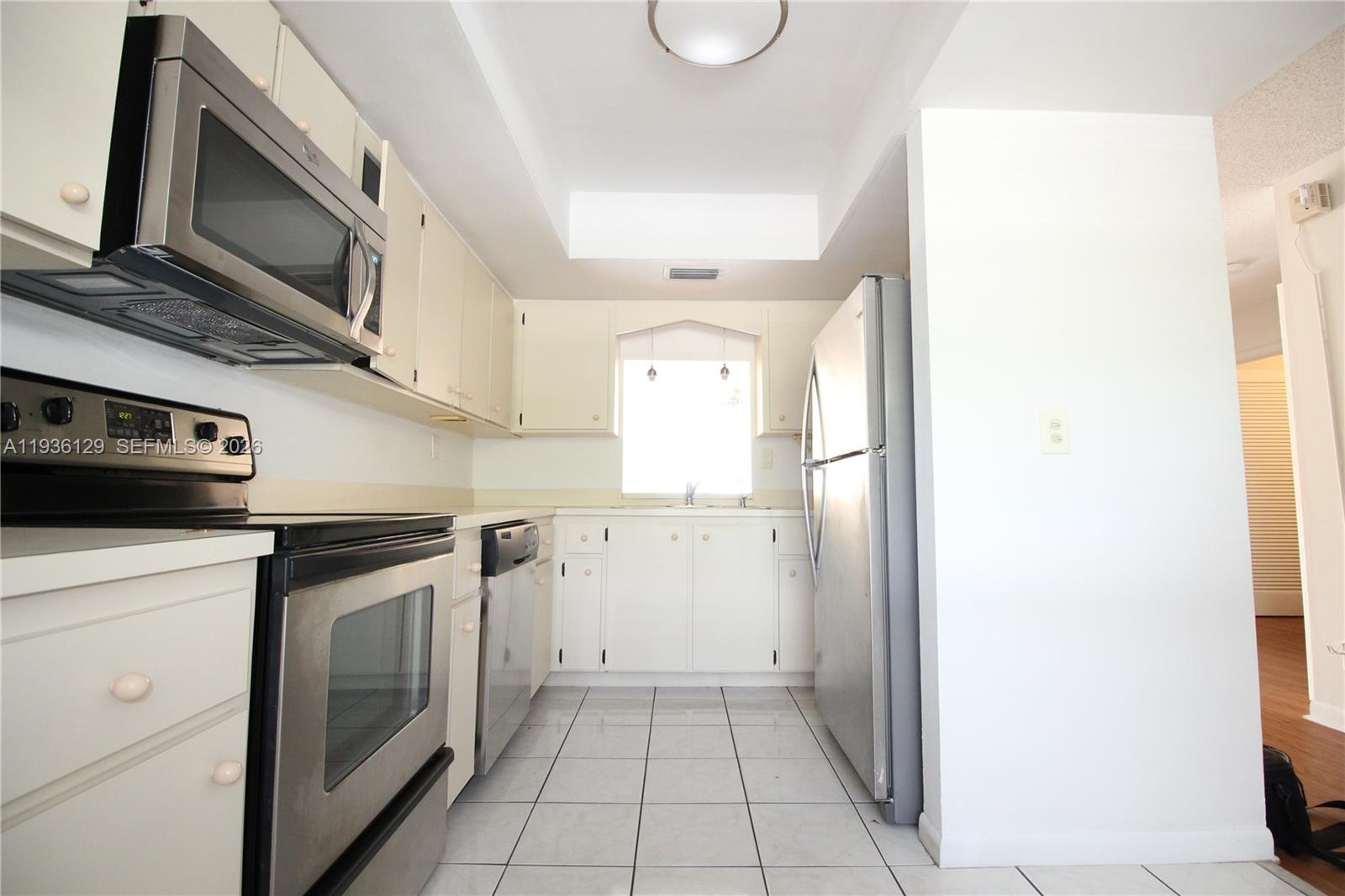 a kitchen with stainless steel appliances granite countertop a stove a microwave and a refrigerator