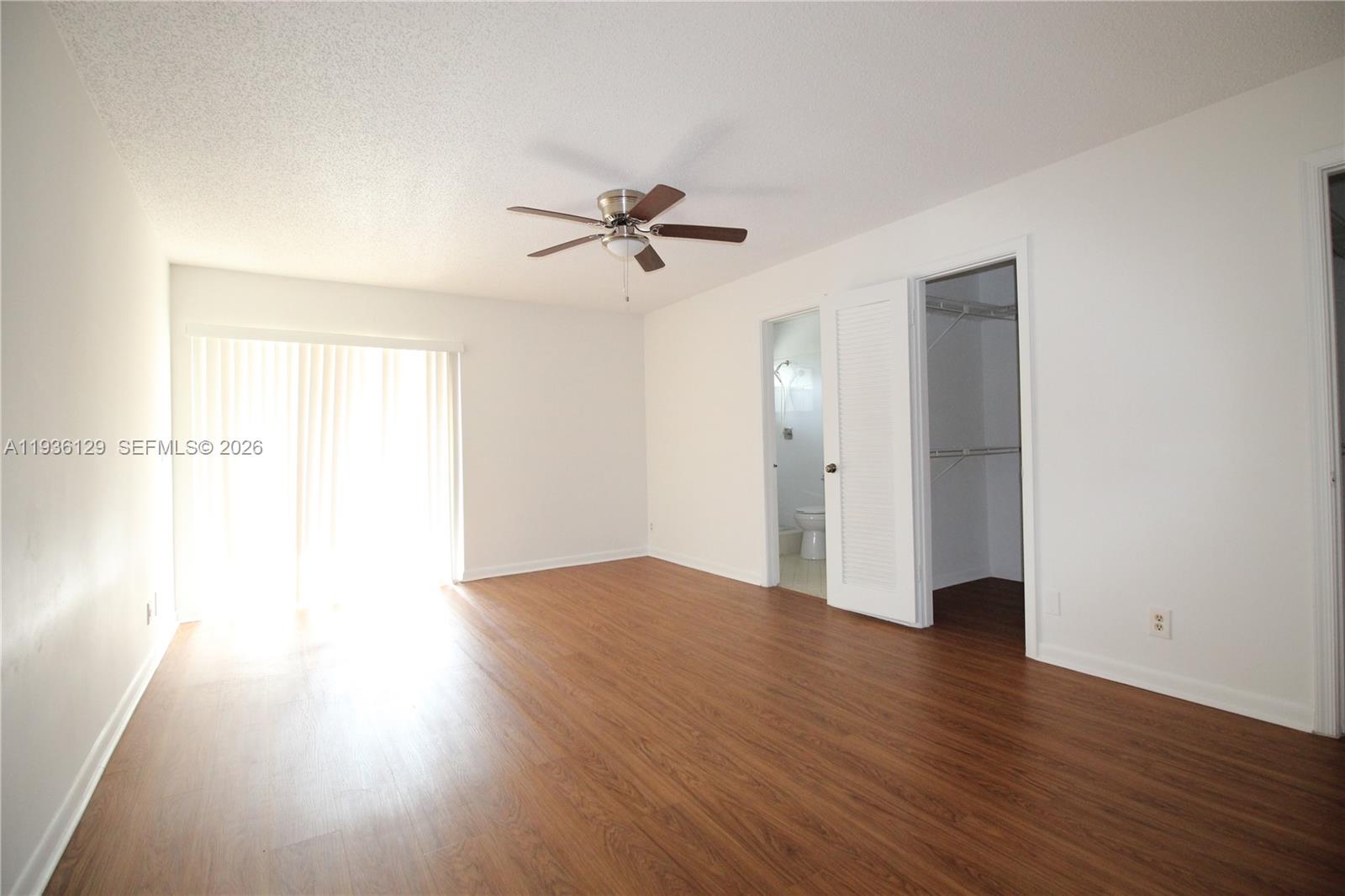 8990 West Sample Road, Unit 206 Coral Springs, FL 33065 - Photo 17 of 28 a view of an empty room with wooden floor