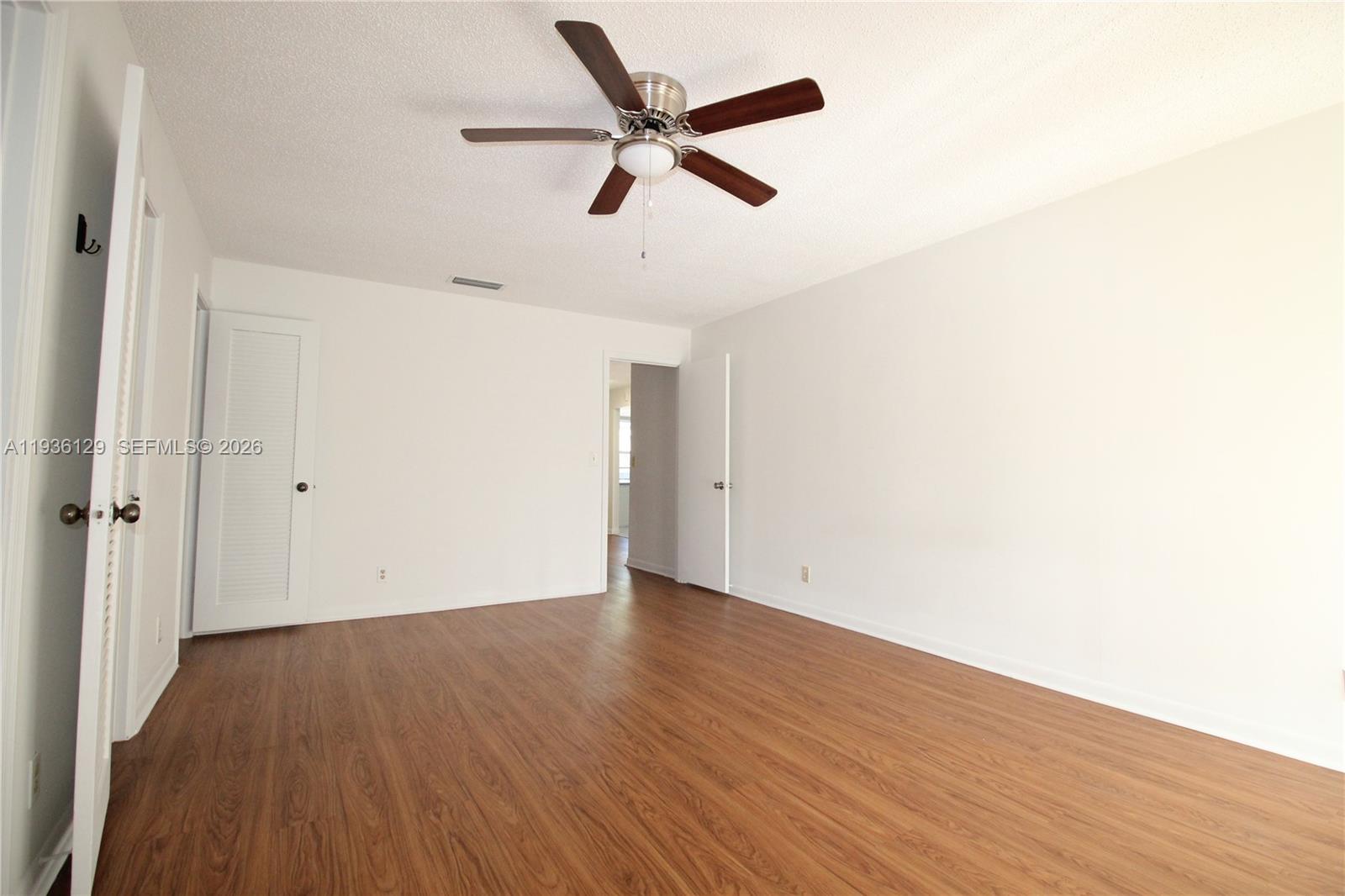 8990 West Sample Road, Unit 206 Coral Springs, FL 33065 - Photo 18 of 28 a view of an empty room with wooden floor