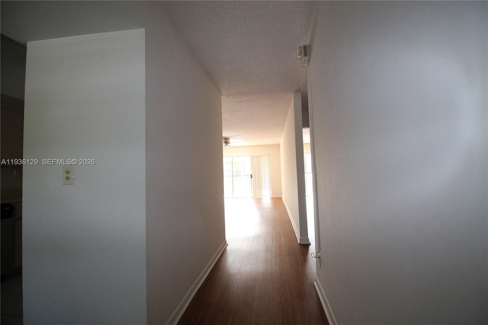 8990 West Sample Road, Unit 206 Coral Springs, FL 33065 - Photo 6 of 28 a view of a hallway with wooden floor