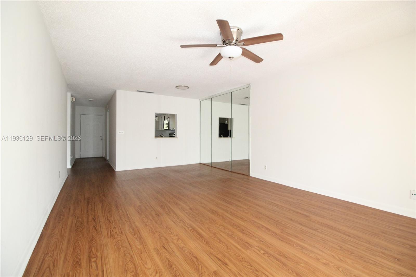 8990 West Sample Road, Unit 206 Coral Springs, FL 33065 - Photo 9 of 28 a view of a livingroom with wooden floor and a ceiling fan