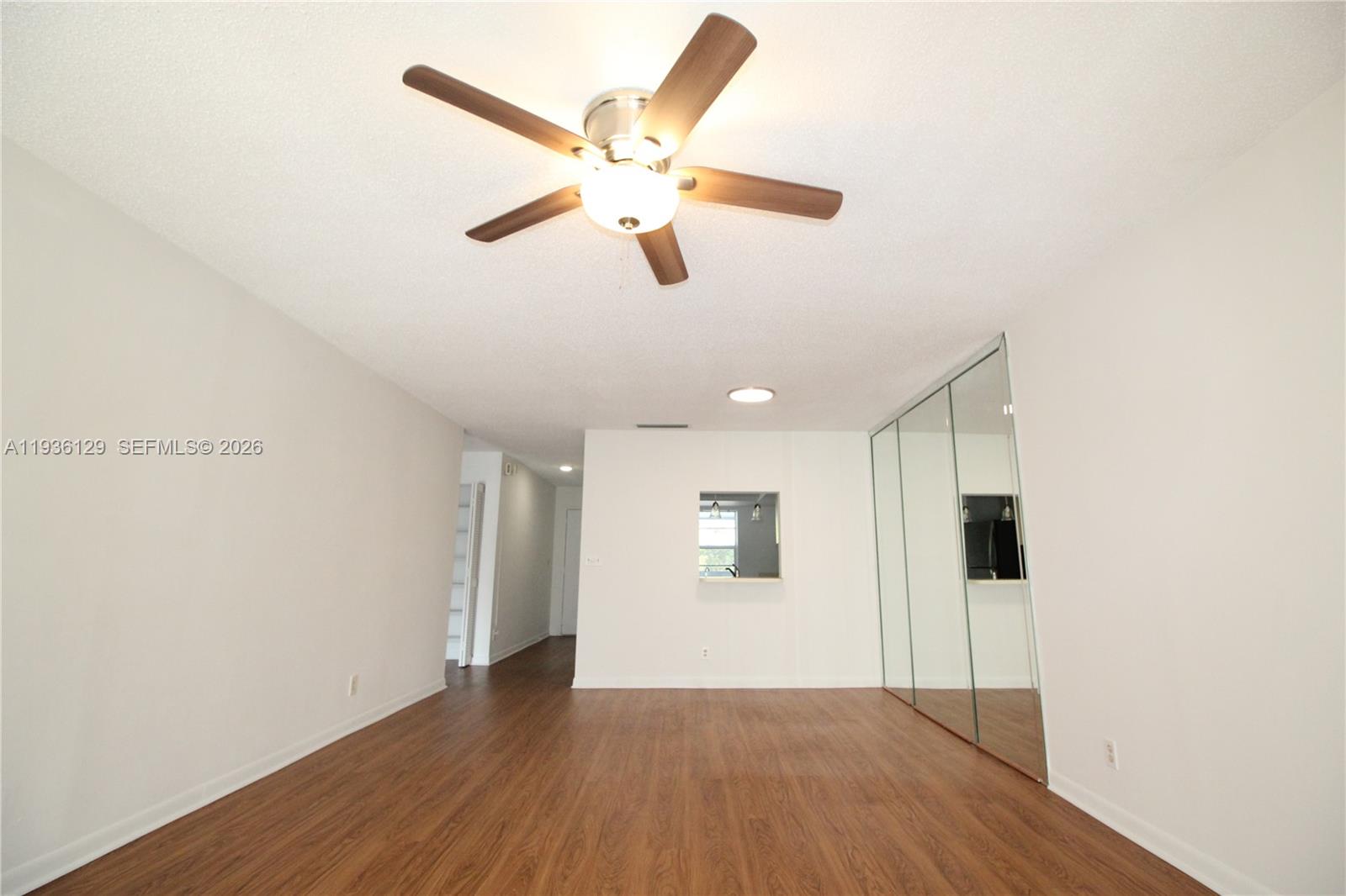 8990 West Sample Road, Unit 206 Coral Springs, FL 33065 - Photo 10 of 28 a view of an empty room with wooden floor