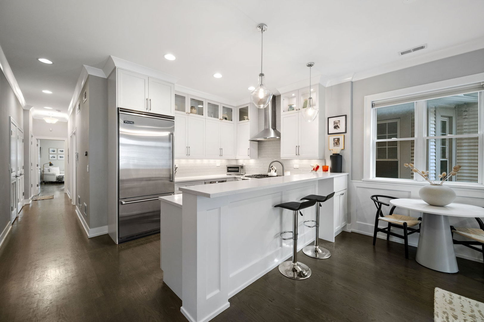 1341 West George Street, Unit 2 Chicago, IL 60657 - Photo 12 of 20 a kitchen with stainless steel appliances kitchen island granite countertop a sink and a refrigerator