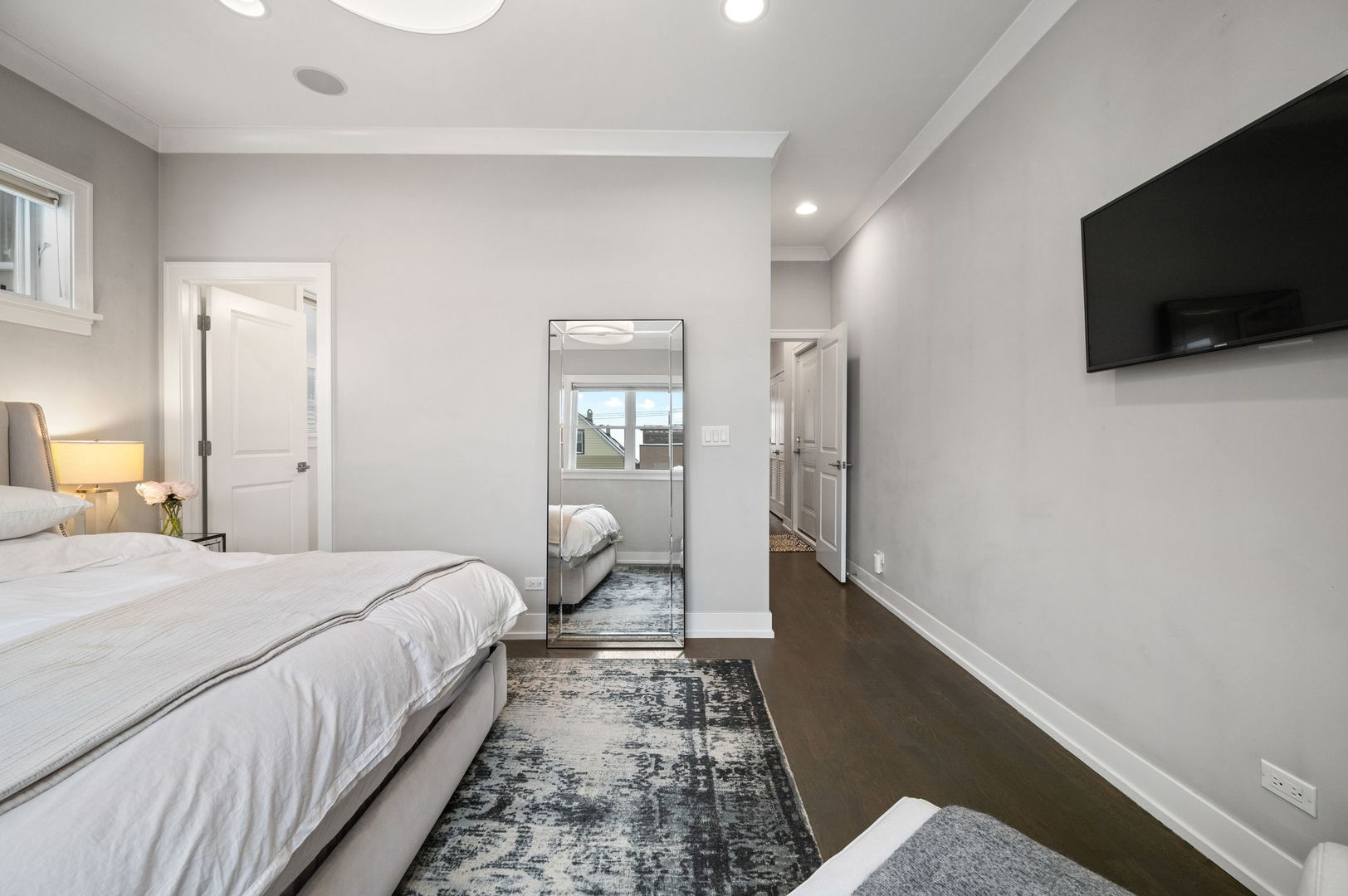 1341 West George Street, Unit 2 Chicago, IL 60657 - Photo 14 of 20 a bedroom with a bed and a flat screen tv