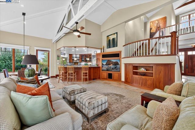 a living room with furniture a fireplace and a chandelier