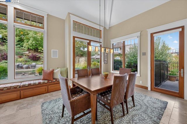 a dining room with furniture and wooden floor