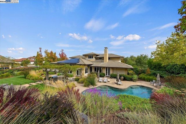 an aerial view of a house with a yard and lake view