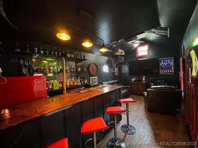 a kitchen with stainless steel appliances a dining table and chairs