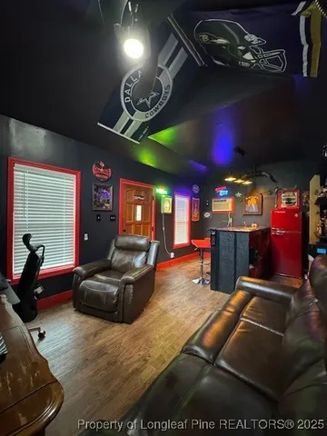 a living room with furniture gym equipment and a flat screen tv
