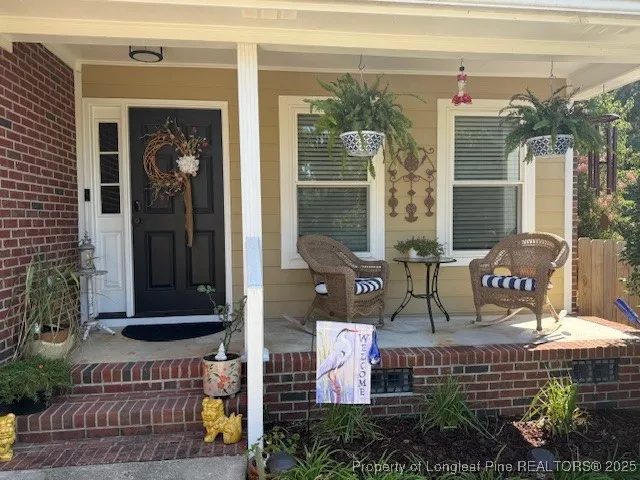a front view of a house with outdoor seating