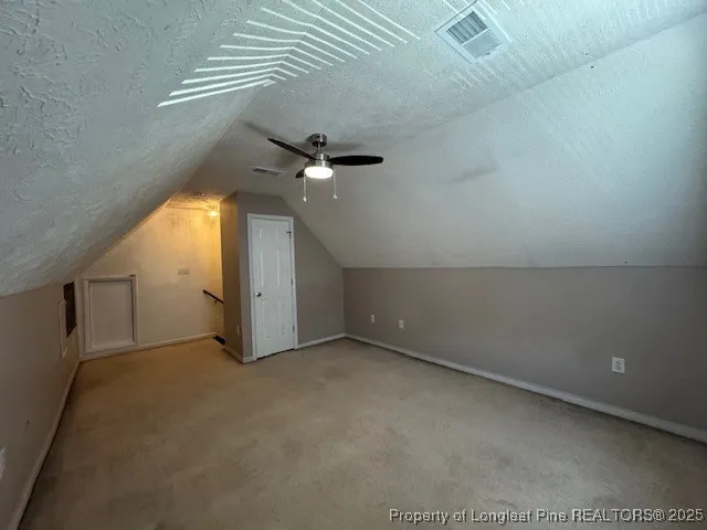 an empty room with a ceiling fan