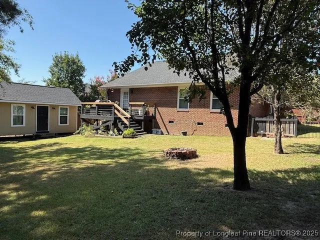 a view of a house with backyard porch and sitting area