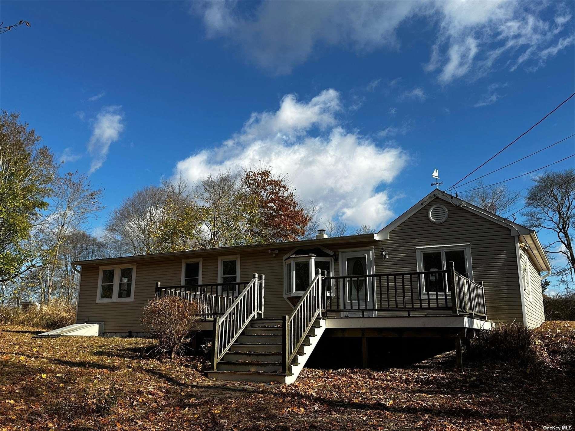 2468 River Road Calverton, NY 11933 - Photo 3 of 20 a front view of a house with yard
