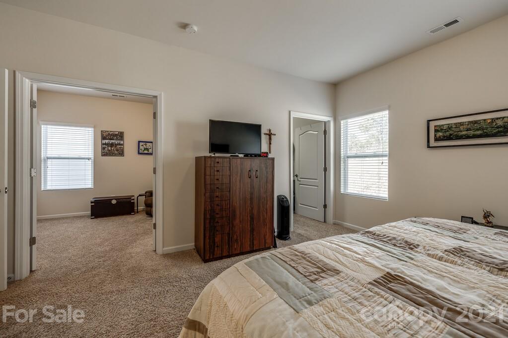 1592 Spring Blossom Trail Fort Mill, SC 29708 - Photo 13 of 36 a bedroom with a bed and a television