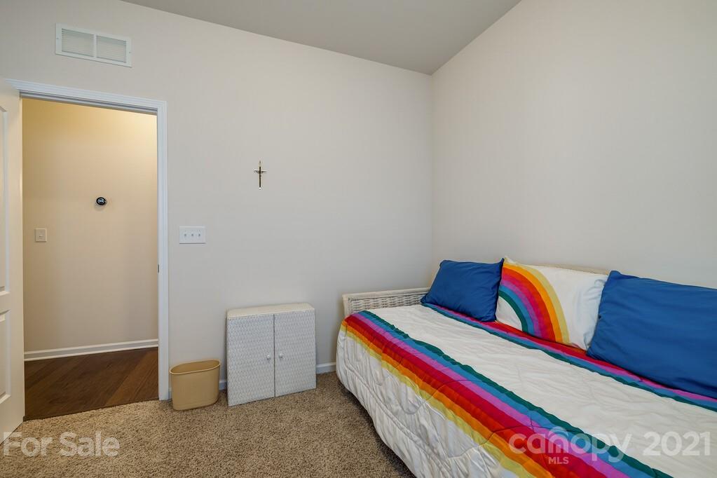 1592 Spring Blossom Trail Fort Mill, SC 29708 - Photo 15 of 36 a room with a bed and a lamp on dresser