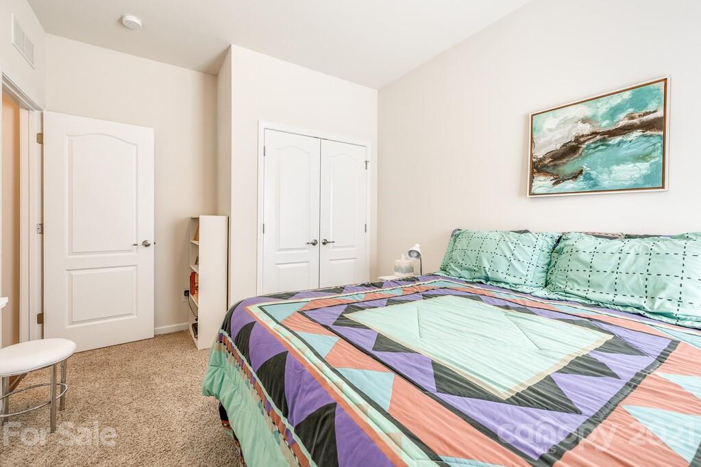 1592 Spring Blossom Trail Fort Mill, SC 29708 - Photo 17 of 36 a bedroom with a bed and a painting on the wall