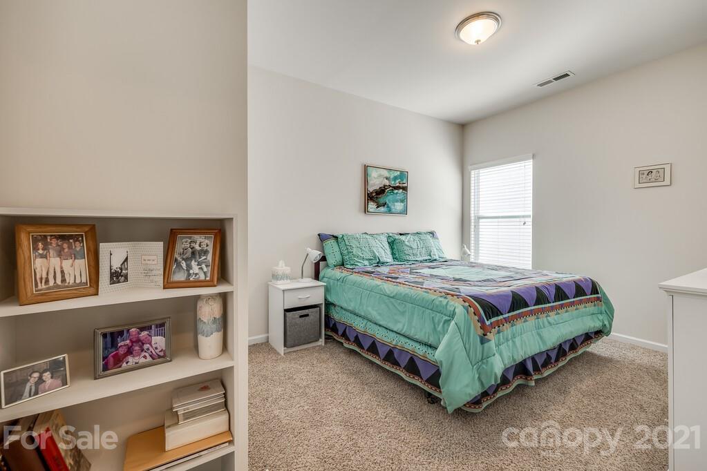 1592 Spring Blossom Trail Fort Mill, SC 29708 - Photo 18 of 36 a bedroom with a bed and window