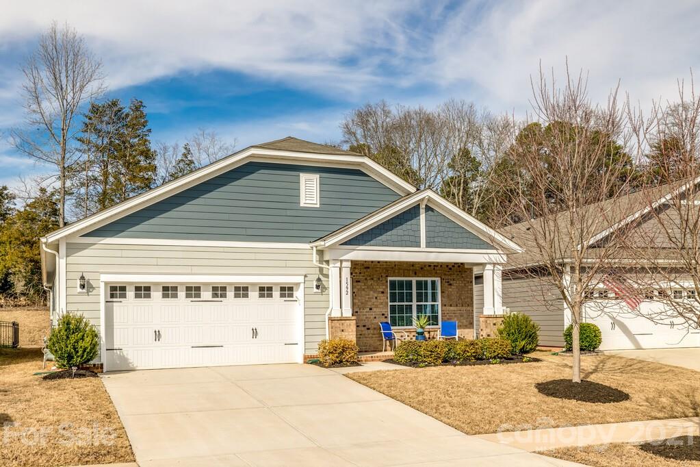 1592 Spring Blossom Trail Fort Mill, SC 29708 - Photo 3 of 36 a front view of a house with basket ball court and outdoor seating