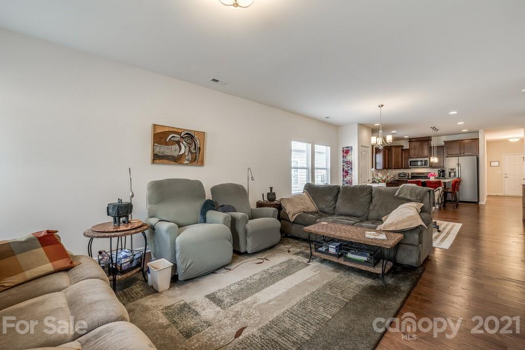 1592 Spring Blossom Trail Fort Mill, SC 29708 - Photo 21 of 36 a living room with furniture and a wooden floor
