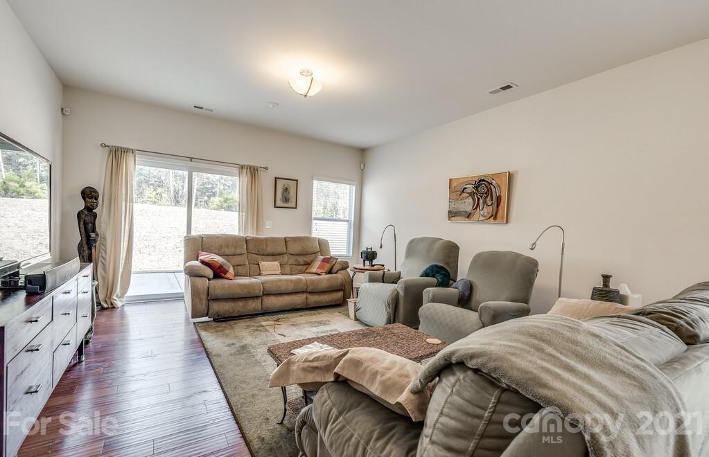 1592 Spring Blossom Trail Fort Mill, SC 29708 - Photo 22 of 36 a living room with couches and a flat screen tv