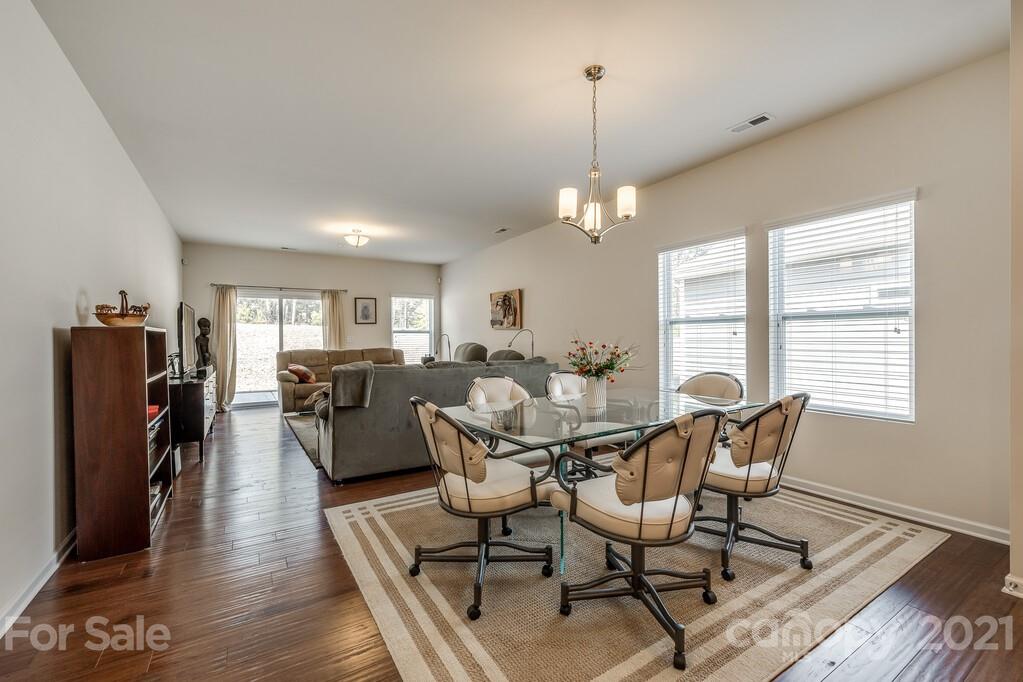 1592 Spring Blossom Trail Fort Mill, SC 29708 - Photo 25 of 36 a view of a dining room with furniture window and wooden floor