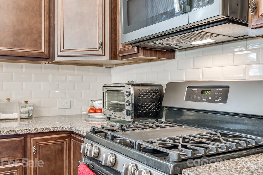 1592 Spring Blossom Trail Fort Mill, SC 29708 - Photo 27 of 36 a stove top oven sitting inside of a kitchen