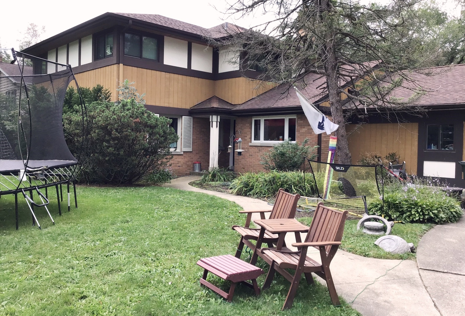 a front view of a house with a yard table and chairs