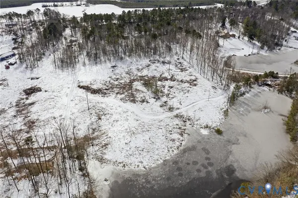 a view of a dry yard covered with snow in the background