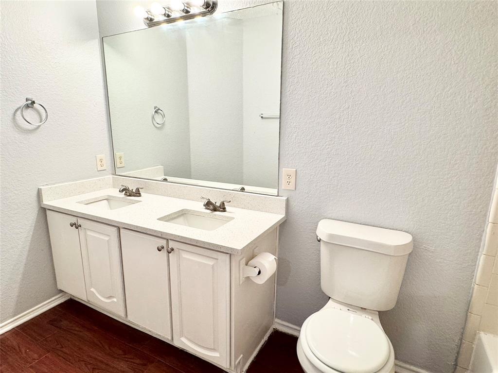 6723 Ambercrest Drive Arlington, TX 76002 - Photo 13 of 31 a bathroom with a toilet sink and mirror