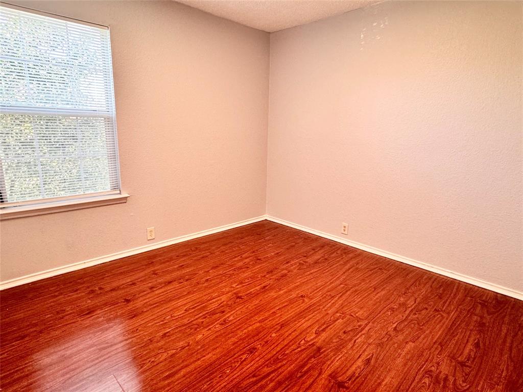 6723 Ambercrest Drive Arlington, TX 76002 - Photo 18 of 31 a view of empty room with wooden floor and fan